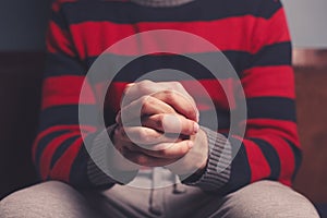 Man with hands folded in prayer