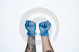 A man hands and gestures in Blue rubber glove shows fist scat sign isolated on white background
