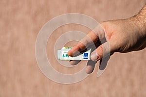 Man hands giving money like a bribe or tips. Holding EURO banknotes on a blurred background  EU currency