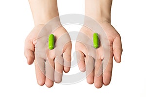 Man hands giving two big blue pills. Make your choice of healthcare. Herbal consept.