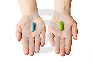 Man hands giving two big pills. Blue and green. Make your selection. calm nerves and health. Choose your side