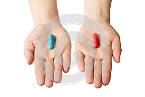 Man hands giving two big pills. Blue and red. Make your selection. Health or ill. Choose your side