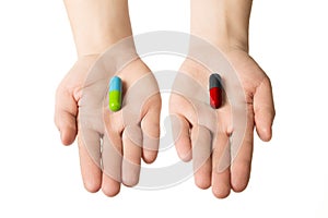 Man hands giving two big pills. Green blue and red black. Make your selection. healthy lifestyle or bad habits. Choose your side