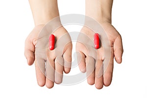 Man hands giving two big red pills. Make your choice consept. excitation and adrenalin