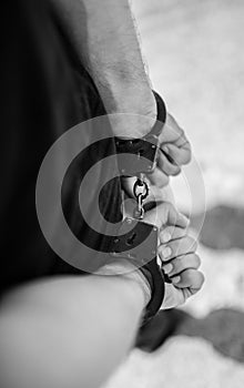 A man hands in handcuffs.