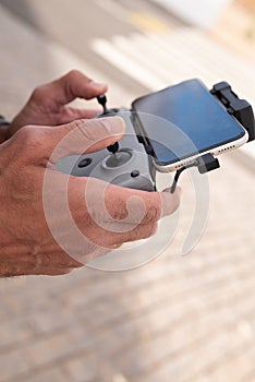 man hands handling drone controller