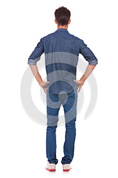 Man with hands on hips from back