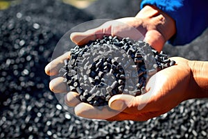 Man hands hold black granules biochar pellets. Handful of charcoal pellets fuel in a person hands. Organic biochar derived made photo