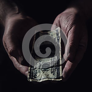 Man hands hold money US dollars on a black background, close-up. US