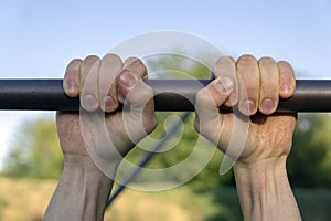 Man Hands Holding bar for pull ups