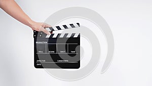 A man with hands is holding black Clapperboard or movie slate. it use in video production ,film, cinema industry.It is white