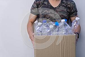 Man hands holding brown recycle paper garbage bin box with recyclable plastic bottle s, garbage for recycling. waste management