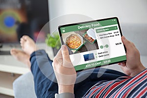 Man hands holding computer tablet with app delivery food