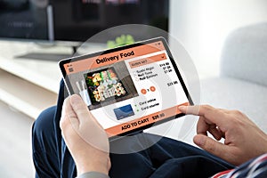 Man hands holding computer tablet with app delivery food