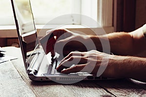 Man Hands holding credit card and using laptop in the evening