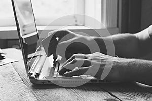 Man Hands holding credit card and using laptop in the evening