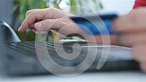 Man Hands Holding Credit Card And Using Laptop To Buy.