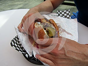 Man hands holding hamburger