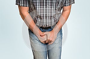 Man with hands holding his crotch, he wants to pee