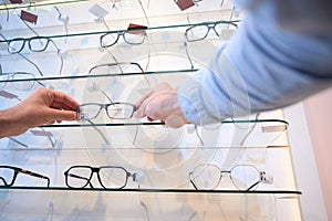 Man hands is holding the luxury eye glasses and choosing it for gift