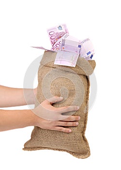Man hands holding money bag full with euro bills