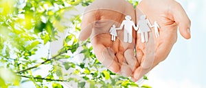 Man hands holding paper cutout of family