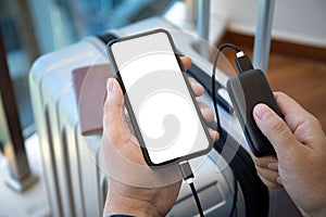 Man hands holding phone with isolated screen and powerbank suitcase