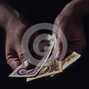 Man hands holding USSR rubles, money on a black background, close-