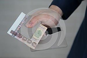 Man hands holding wallet with credit cards and stack of money