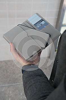 Man hands holding wallet with credit cards and stack of money