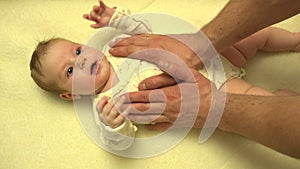 Man Hands Massaging Newborn Baby Body. Closeup. 4K UltraHD, UHD