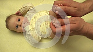 Man Hands Massaging Newborn Baby Body. Closeup. 4K UltraHD, UHD