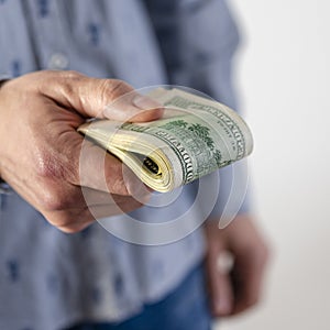 A man hands over a thick wad of dollars