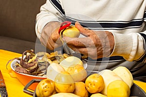 Man hands peeling potato