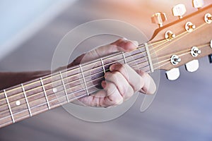 Man hands playing acoustic guitar  close up chord guitar player Musical instrument for recreation or hobby passion concept