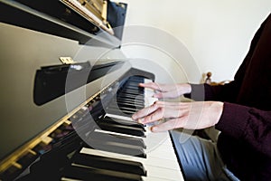 Man hands playing big piano