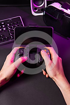 Man hands playing a computer game with a game joystick.