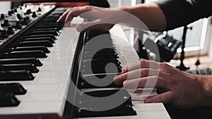 Man hands playing on a double keyboards closeup