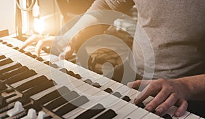 Man hands playing on a double keyboards closeup