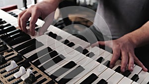 Man hands playing on a double keyboards closeup