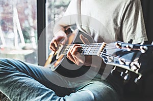 Man hands playing on guitar - close up image