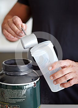 Man, hands and preparing protein shake for nutrition, muscle gain or body mass product and supplement. Hand of male