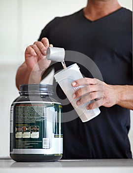 Man, hands and preparing whey protein shake for nutrition, muscle gain or body mass supplement. Hand of male bodybuilder