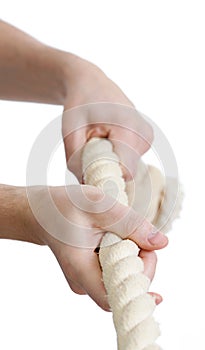 Man hands pull a rope. Isolated white background