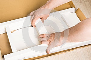 Man hands ready for assembling furniture from box