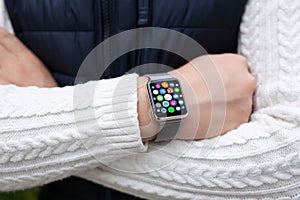 Man hands smart touch watch with home screen icons apps