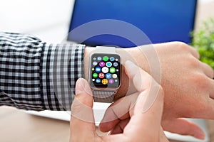 Man hands smart touch watch with home screen icons apps