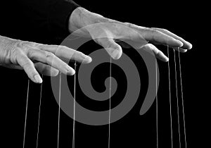 Man hands with strings on fingers. Dominator, abuser using power to make person feel humiliated. Manipulation, negative