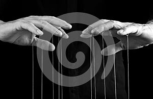 Man hands with strings on fingers. Manipulation, control, power, abuse concept. Black and white