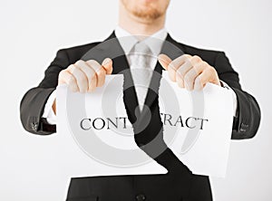 Man hands tearing contract paper